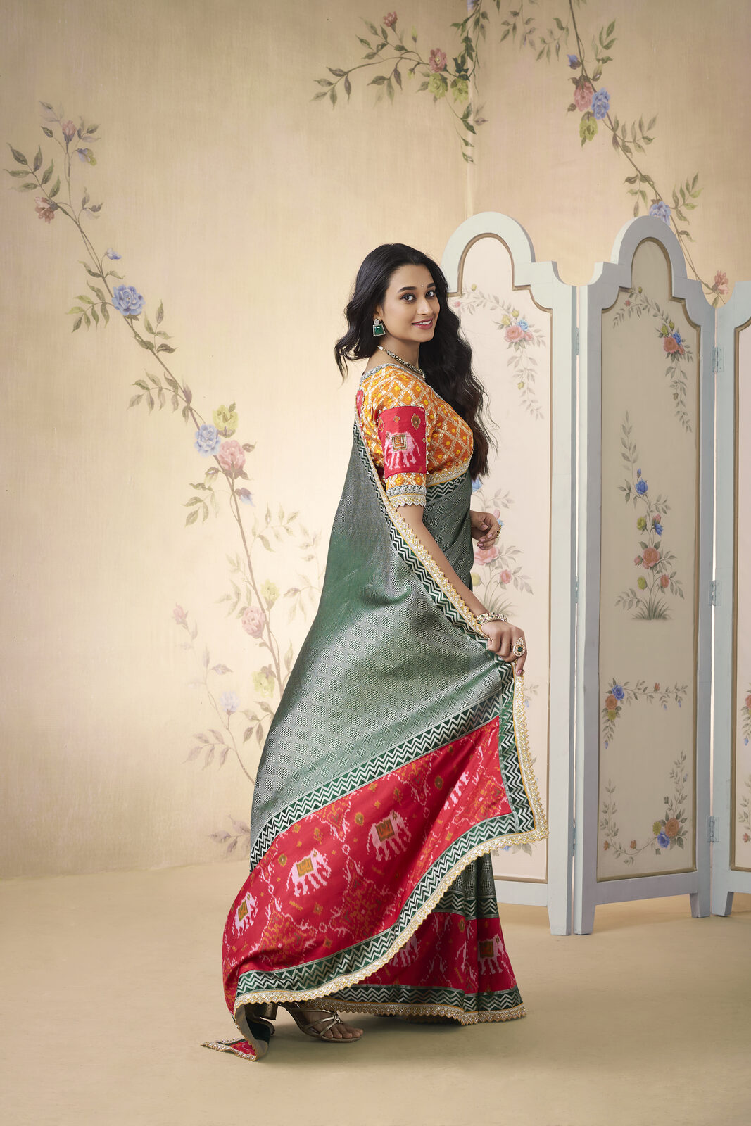 Editorial portrait of a bride in a pure mulberry silk Kanjivaram saree with contrast korvai border