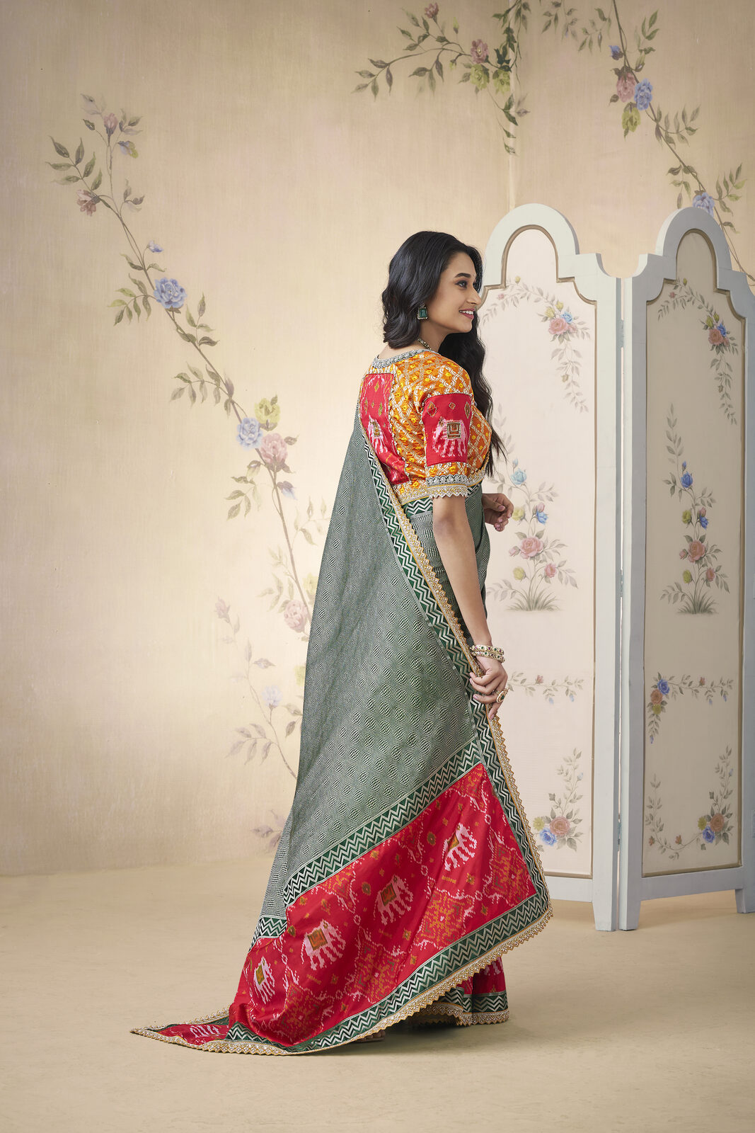 Editorial portrait of an NRI patron in a heritage handloom saree chosen via a private video viewing