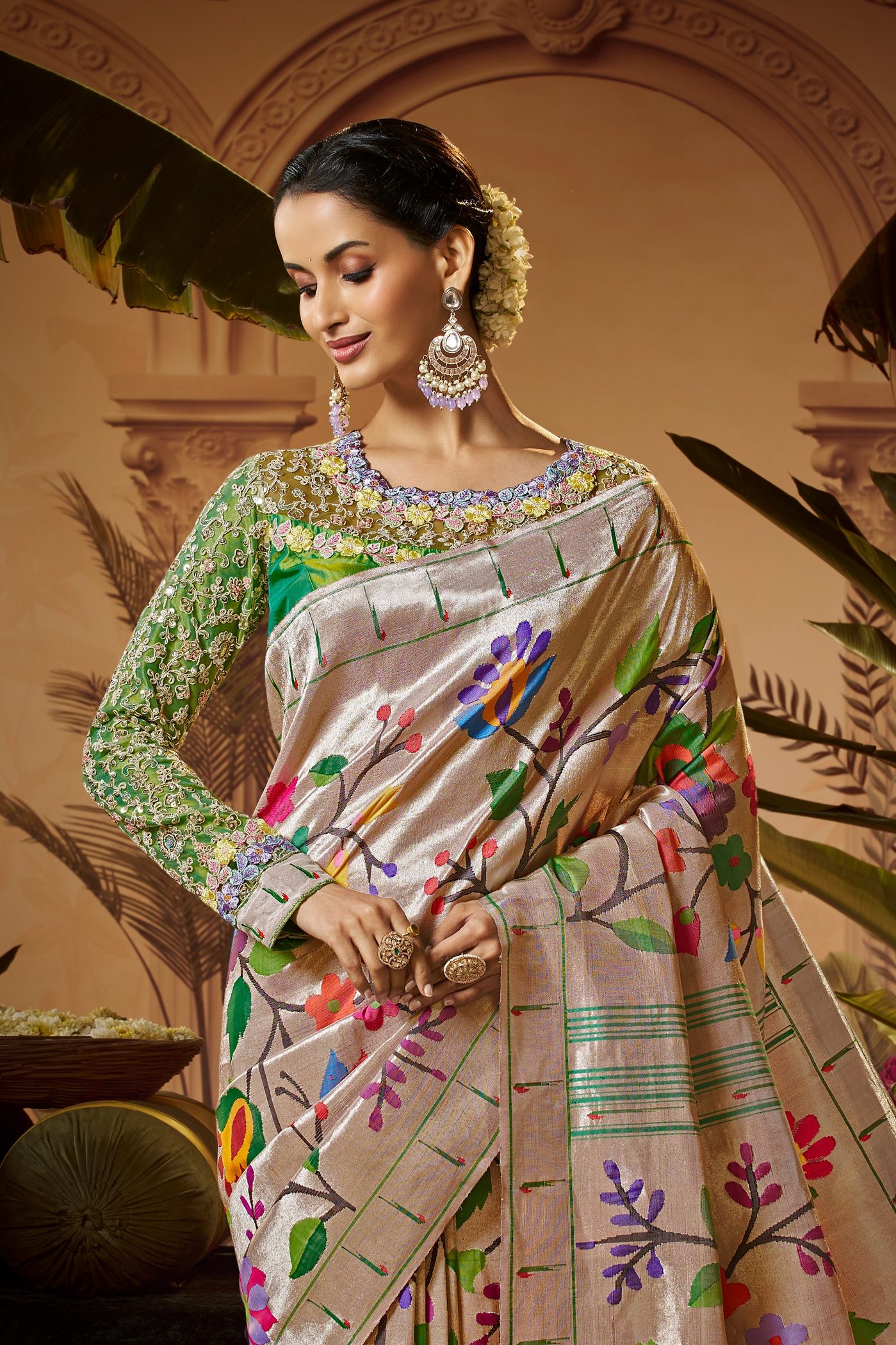 Ivory Paithani silk saree with multicoloured floral buttas and a pistachio embroidered blouse, photographed in a courtyard set