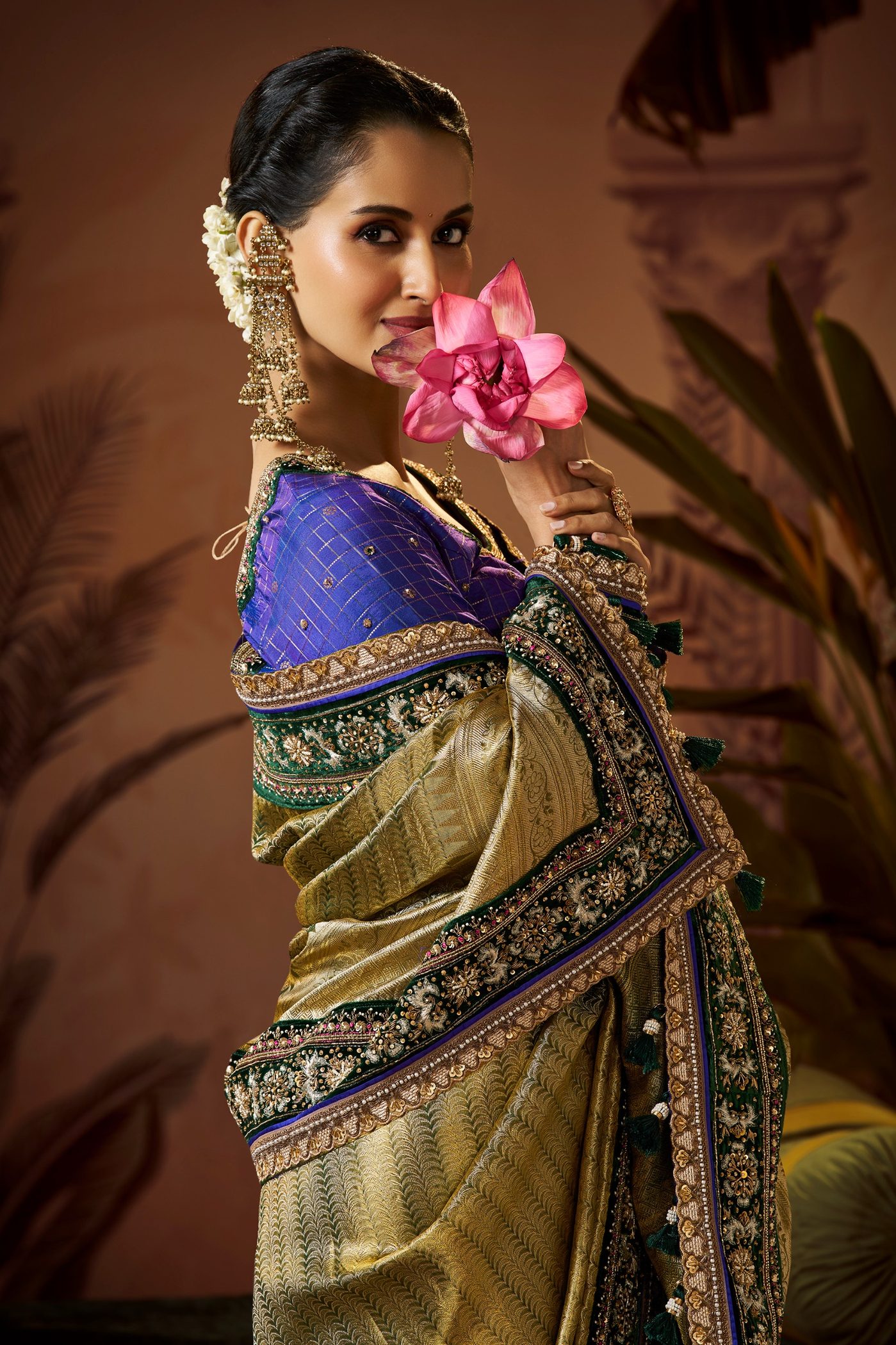 Olive gold Kanjivaram saree with a navy embroidered border styled with a royal blue blouse