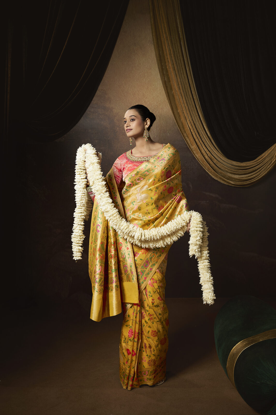 Model in a heavy mustard Kimkhwab brocade bridal saree with full zari pallu