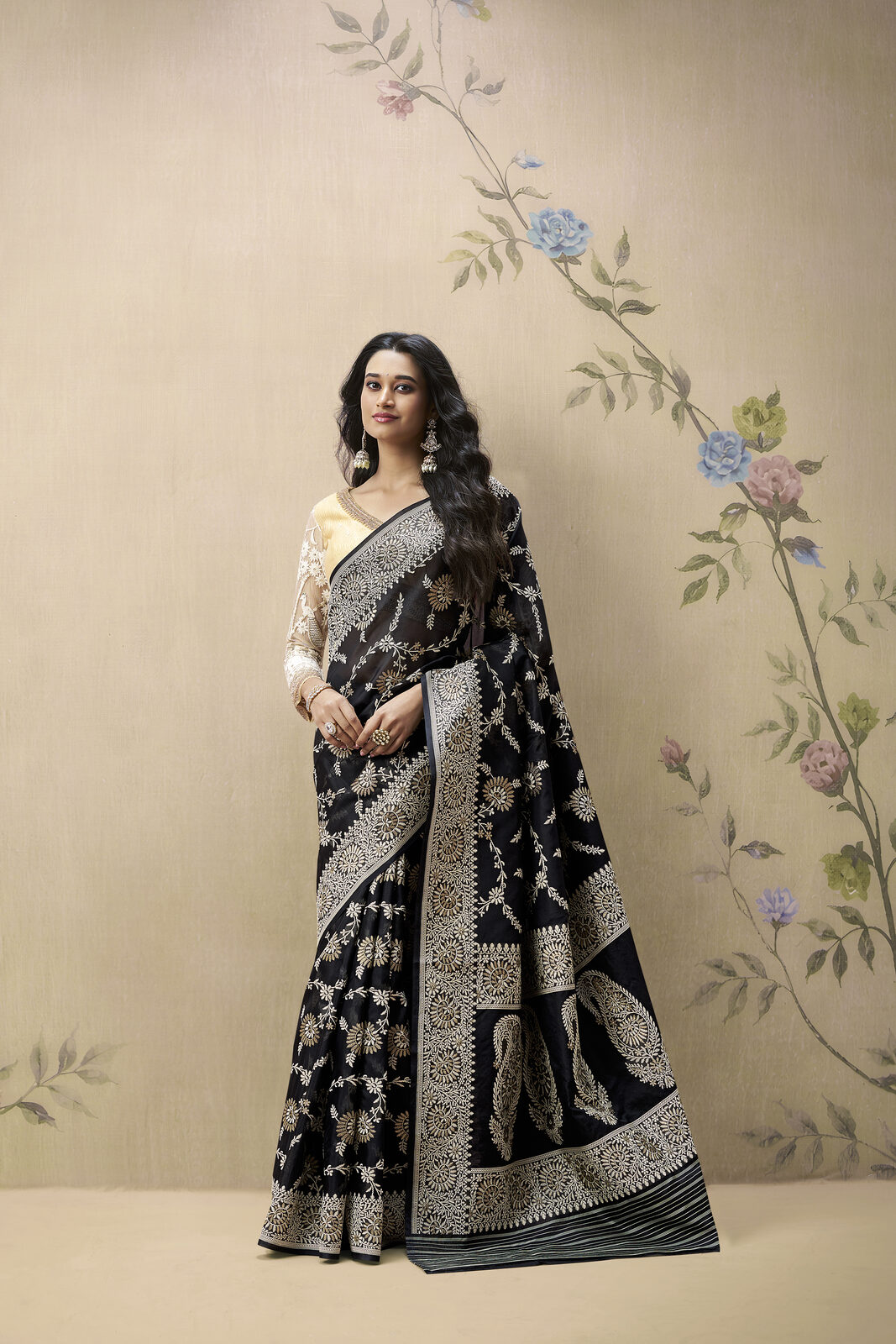 Model in a featherweight black-and-gold organza Banarasi saree with hand-woven zari