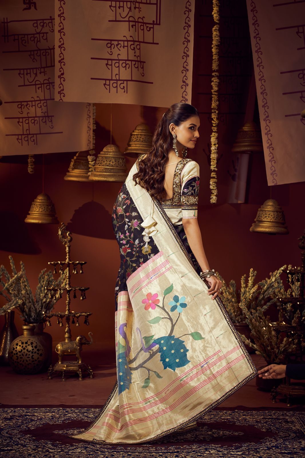 Black floral Paithani saree with an ivory pallu carrying woven blue and rose flowers