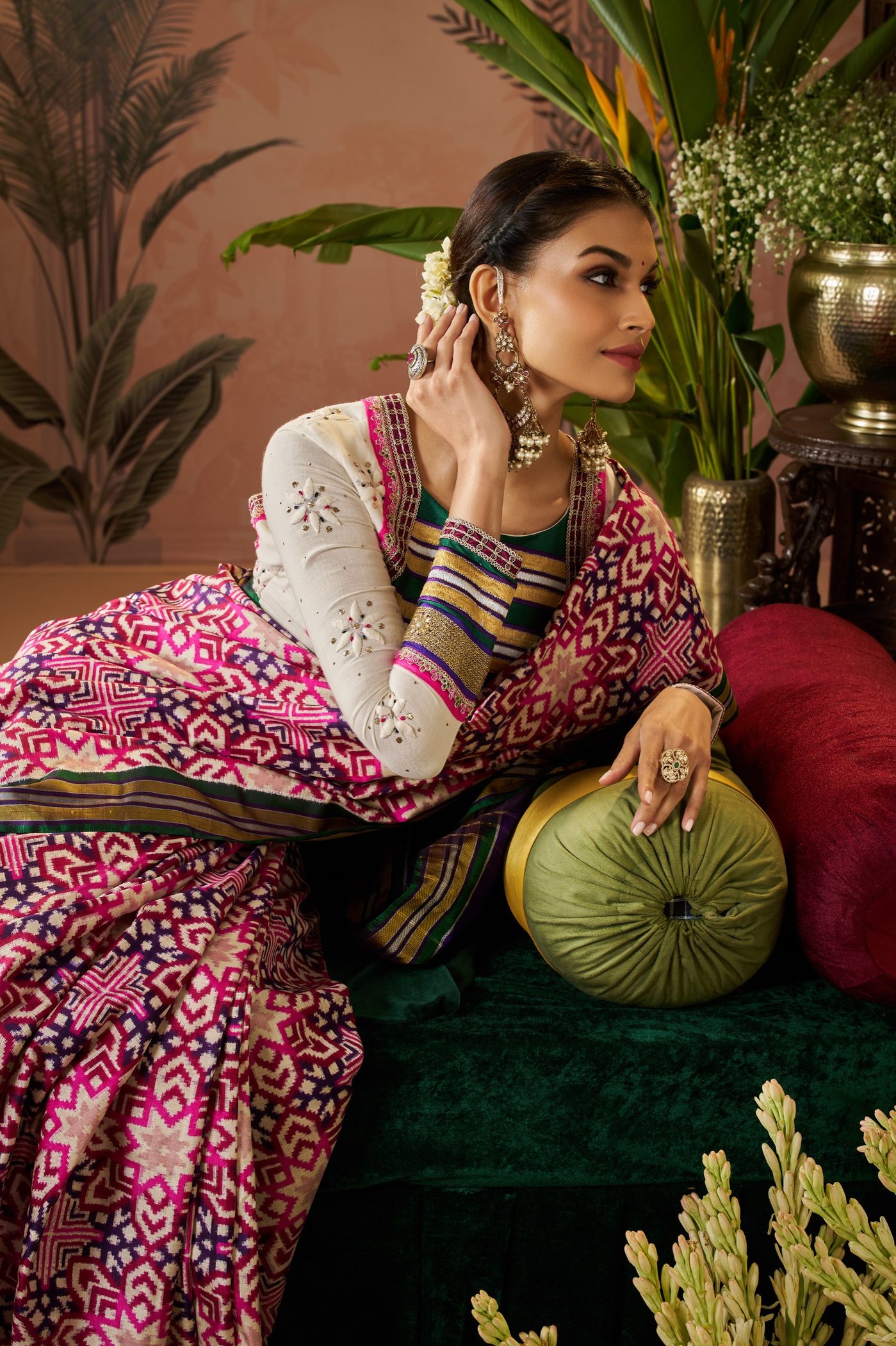 Rose pink Bandhani saree with a woven Patola pallu, styled with ivory embroidered sleeves