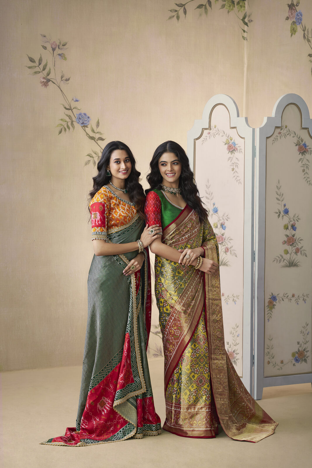 Two women in pure Kanjivaram and patola silks at a Hyderabad atelier viewing