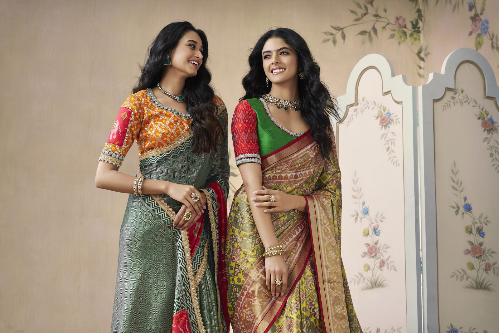 Two NRI brides viewing their bridal trousseau sarees together at the atelier