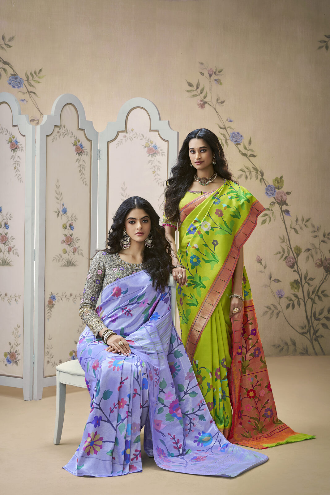 Two models in pure Kanjivaram silks showing the korvai contrast border join