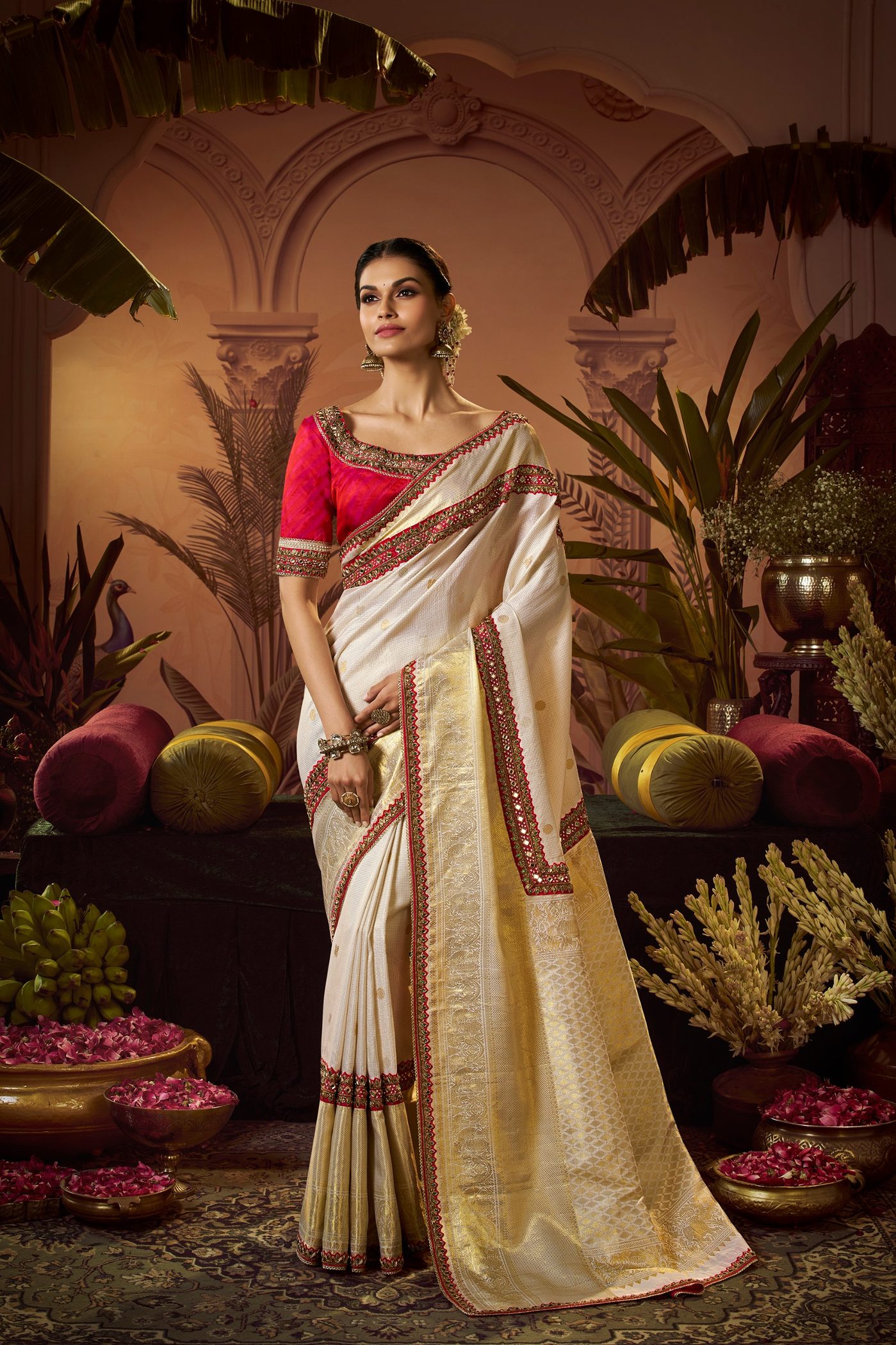 Ivory tissue silk saree with a red and gold woven border and a red embroidered blouse