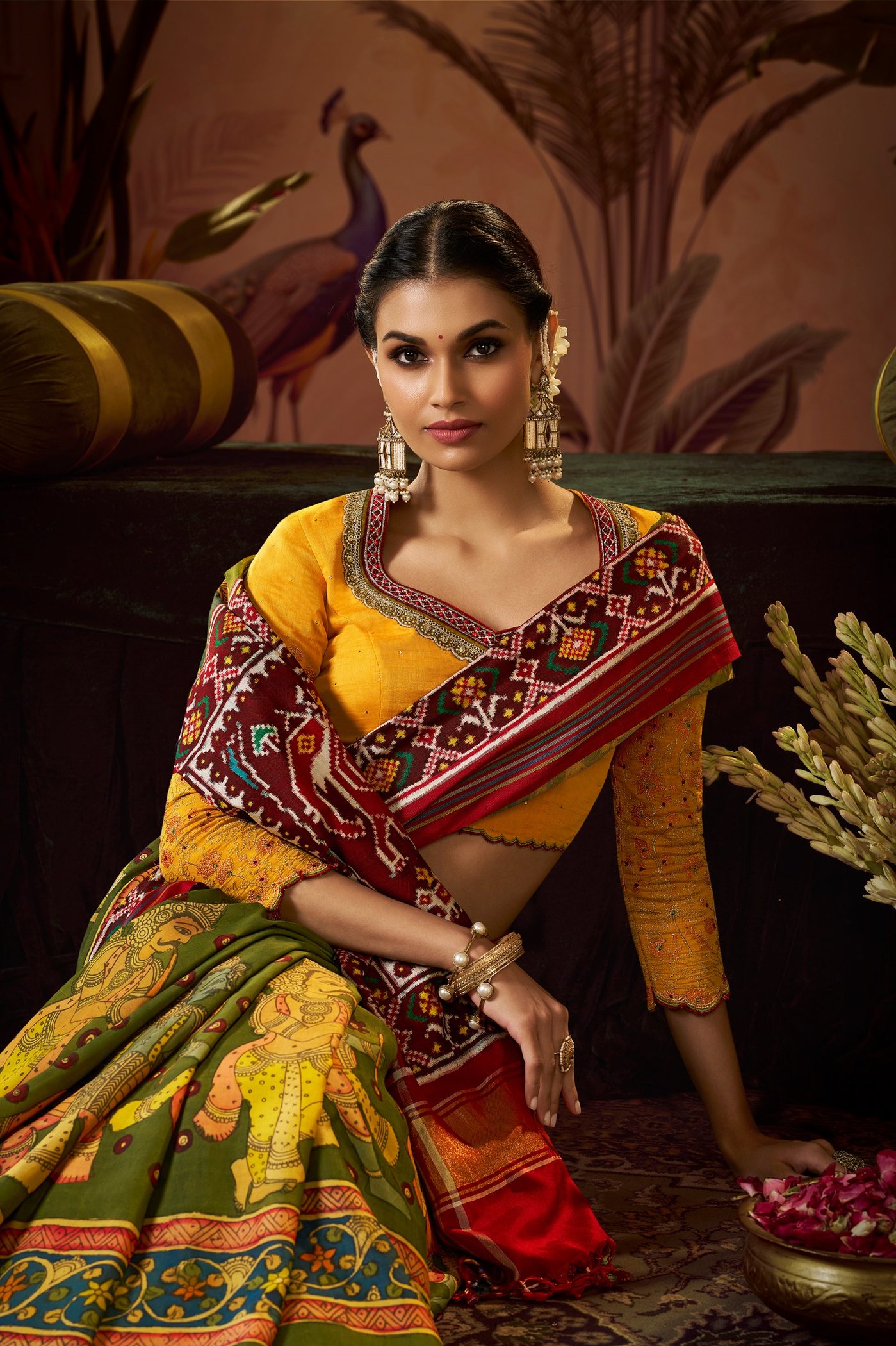 Olive and mustard Patola style saree with a red woven border, styled with a mustard embroidered blouse